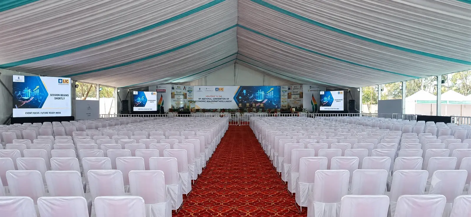 Large institutional programme venue with theatre seating and an integrated stage